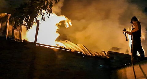 A firefighter tries to douse a fire that broke out at a gloves manufacturing factory, in Chhatrapati Sambhajinagar district, early Sunday morning, Dec. 31, 2023. | PTI
