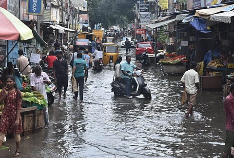 Locals wade through a waterlogged street after heavy rain, in Chennai. (File Photo | P Jawahar)