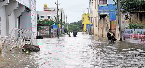 People wading through a flooded street in Madhavaram, Chennai. (File| Shiba Prasad Sahu)