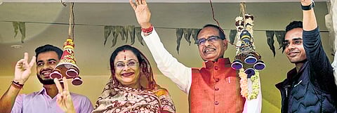 Madhya Pradesh Chief Minister Shivraj Singh Chouhan with family members celebrates BJP’s lead during the counting of votes in Bhopal on Sunday| pti