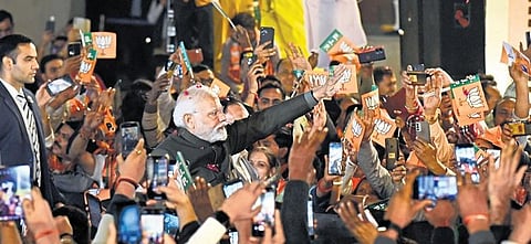 PM Narendra Modi being greeted by supporters as he arrives to attend the BJP’s victory celebrations in New Delhi on Sunday. (Photo| Parveen Negi)