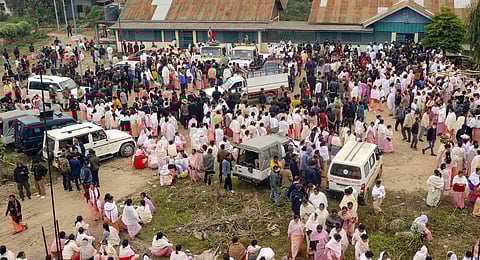 Family members and relatives arrive to claim the bodies of the 13 people who were killed after a gunfight in a border village of Manipur's Tengnoupal district.(Photo | PTI)