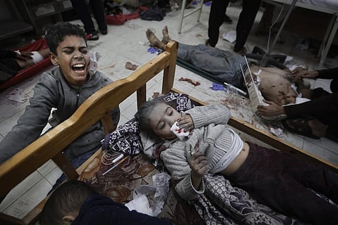 Palestinians wounded in the Israeli bombardment of the Gaza Strip arrive at a hospital in Khan Younis on Friday, Dec. 8, 2023. (AP Photo)