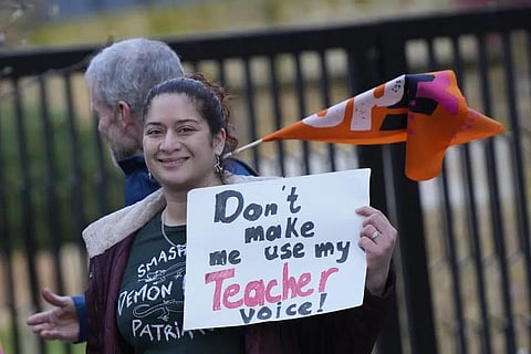 Teachers hold flags and placards on a picketline outside Holland Park School as they go on strike over pay in London, Wednesday, Feb. 1, 2023. (Photo | AP)