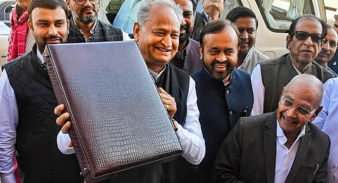 Rajasthan Chief Minister Ashok Gehlot, who also holds the finance portfolio, arrives holding the 'budget briefcase' to present the State Budget 2023-24. (Photo | PTI)
