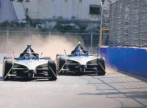 Cars race past each other during the practice session on the track in Hyderabad on Friday