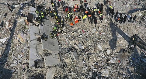 Rescue teams search for people in a destroyed building in Antakya, southeastern Turkey. (Photo | AP)