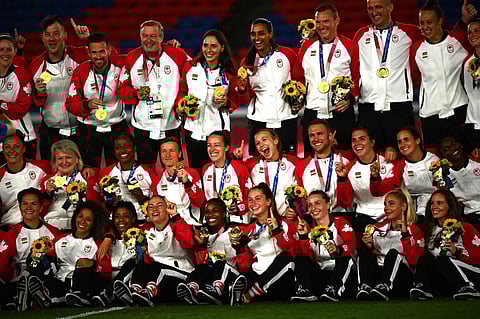 In this file photo taken on August 6, 2021, Canada's women's football team and staff members pose with their Gold Medals during the victory ceremony after the Tokyo 2020 Olympic Games. (Photo | AFP)