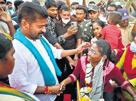TPCC president A Revanth Reddy interacts with family members of SCCL employees in Yellendu mandal of Bhadradri-Kothagudem district on Saturday