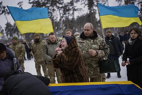 Nina Nikiforovа, 80, cries next to the body of her son Oleg Kunynets, a Ukrainian military serviceman who was killed in the east of the country, during his funeral in Kyiv, Ukraine, Feb. 11, 2023. (Ph