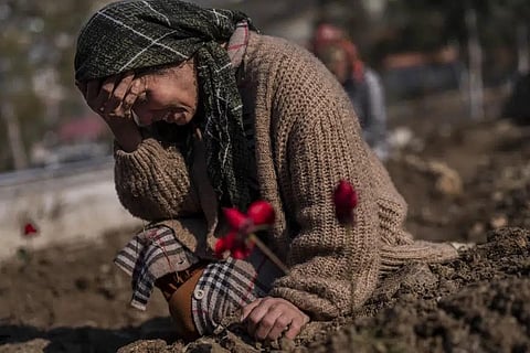 A member of the Vehibe family mourns a relative during the burial of one of the earthquake victims that struck a border region of Turkey & Syria five days ago in Antakya, on Feb 11, 2023. (Photo | AP)