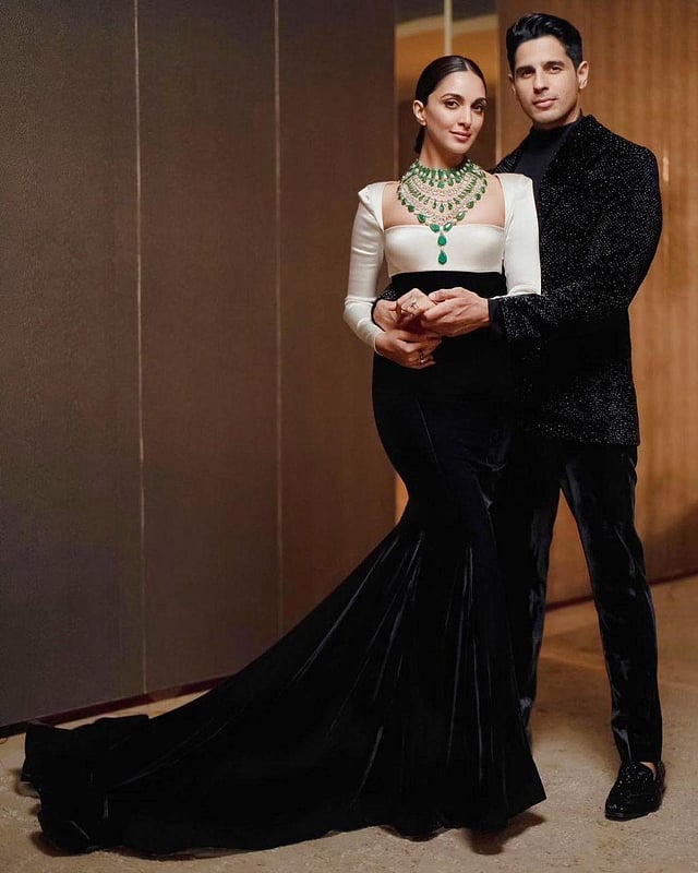 Designer Manish Malhotra captioned this photo of the couple thus: 'The stunning Kiara Advani @kiaraaliaadvani redefines the power of monochrome in our haute-couture illustrious sculptural gown conveying all the elegant aesthetics. The ebony- ivory construction in a velvet satin emphasises the iconic codes with sharp cuts in a wide sleek squared neck and power sleeves romanticised with a fish cut trail. Making a grand statement for the finishing touch,she adorns an exceptional assortment, the look features a magnificent choker, a layered diamond necklace and a long laureate necklace from @manishmalhotrajewellery.' (Photo | Instagram)