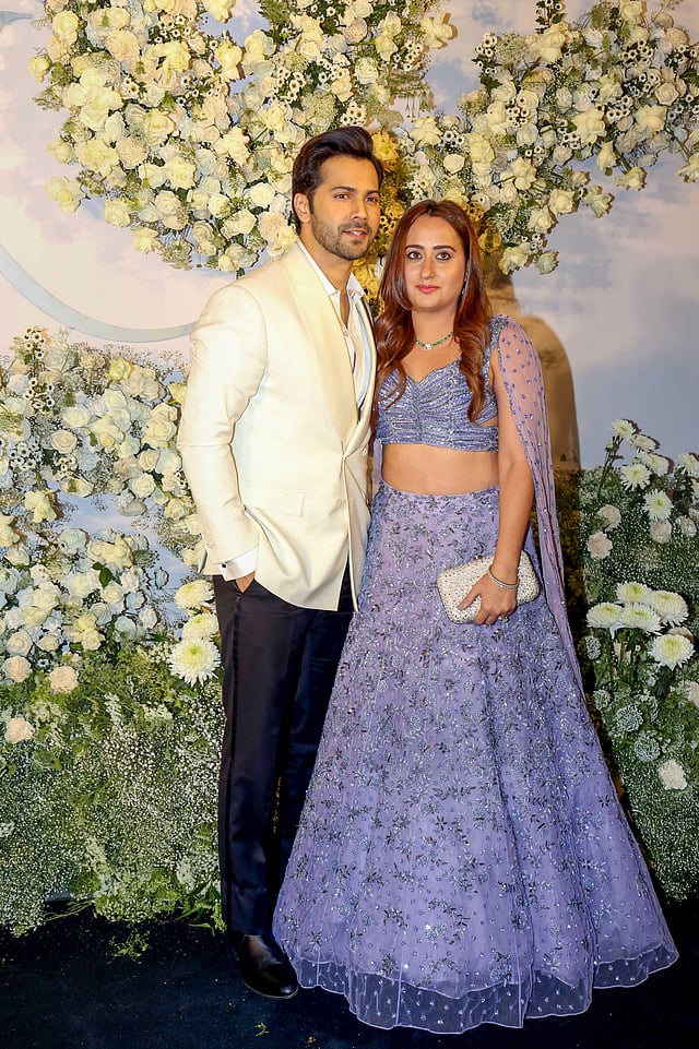 Varun Dhawan poses for photos with his wife Natasha Dalal at the wedding reception of Sidharth Malhotra and Kiara Advani in Mumbai. (Photo | PTI)