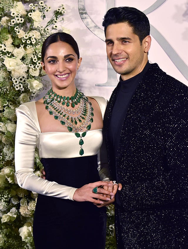 Kiara and Sidharth are all smiles at their wedding reception on February 12. Kiara wore a Manish Malhotra cocktail monochrome gown while Sidharth chose to wear a velvet Manish Malhotra outfit. (Photo | ANI)