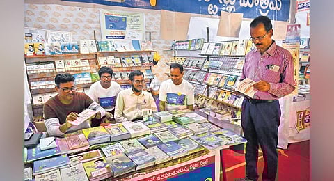 An elderly person reading a book at the festival on Monday I Prasant Madugula