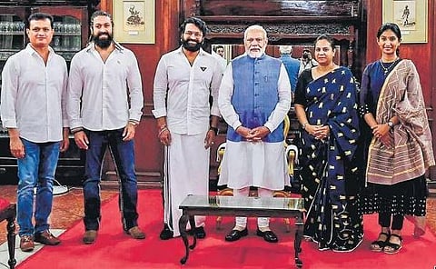 PM Modi flanked by producer Vijay Kiragandur, actors Yash and  Rishab Shetty, Ashwini, wife of later actor Puneeth and Aiyyo Shraddha, in Bengaluru on Monday