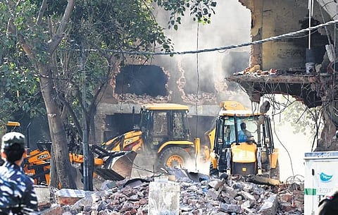 Heavy machinery being used to demolish alleged illegal structures during an  anti-encroachment drive by DDA in Mehrauli on Tuesday | shekhar yadav