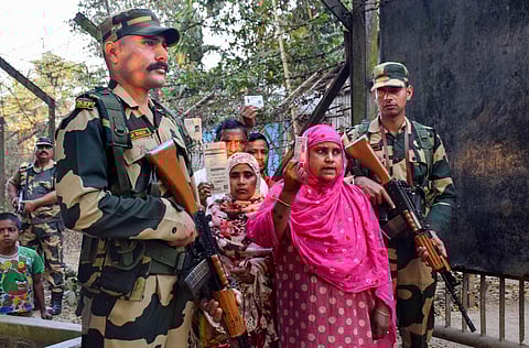 People show voter cards as Border Security Force (BSF) personnel patrol at Indo-Bangladesh border ahead of the Tripura Assembly elections. (Photo | PTI)