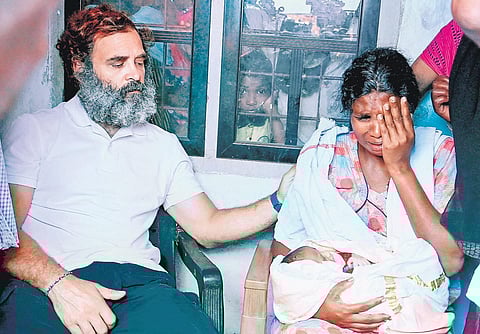 Rahul Gandhi consoles the wife of Viswanathan at the latter’s house. The tribal youth was found hanging on the Kozhikode Medical College premises last week. (Photo | E Gokul)