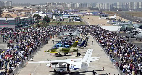 Visitors take a look at the aircraft on display at the 14th edition of Aero India. (Photo | Nagaraja Gadekal, EPS)
