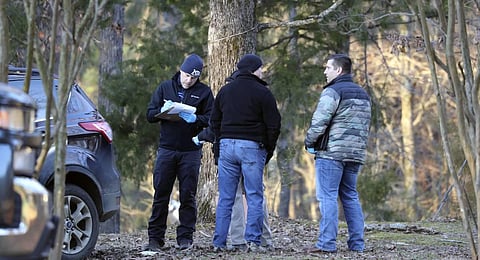Law enforcement personnel investigate the scene of multiple shootings on Arkabutla Dam Road in Arkabutla. (Photo | AP)
