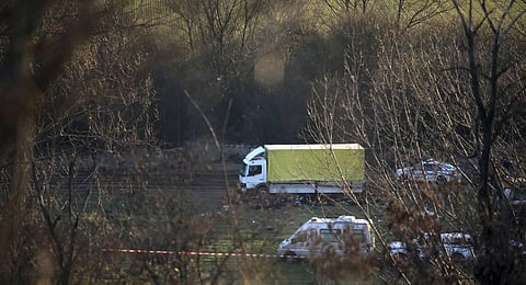 The bodies of 18 migrants lie on the ground near an abandoned truck, at the village of Lokorsko, near Sofia, Bulgaria. (Photo | PTI)