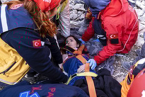 Rescue workers and medics pull out a person from a collapsed building in Antakya, Turkey, Feb. 15, 2023.  (Photo | AP)