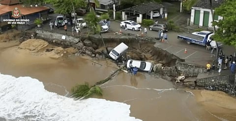 This photo provided by the Sao Paulo Government shows vehicles fallen from an elevated area along the beach in Sao Sebastiao, east of Sao Paulo, Brazil.(Photo | AP)