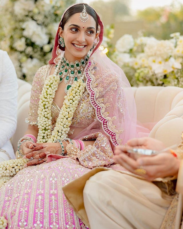 Designer Manish Malhotra captioned the photo thus: 'Our bride @kiaraaliaadvani expressing peak joy dressing in a royal combination of saccharine tints of pink and crystals in our regal bridal lehenga.  Our bride gleams royal radiance in our bridal set in natural diamonds and Zambian emeralds from the Manish Malhotra High Diamond jewellery collection.' (Photo | Manish Malhotra Vows Instagram)