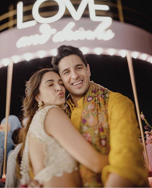 Kiara looked stunning in a white Manish Malhotra lehenga complete with an embellished yellow dupatta and polki jewellery. Sidharth looked dapper in his yellow Manish Malhotra kurta, salwar, and multi-hued stole. (Photo | Kiara Advani Instagram)