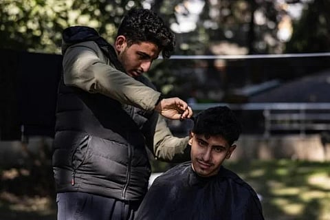 'We need to move on': Student Mohammed al-Hamo cuts hair of people displaced by earthquake. (Photo | AFP)