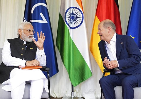 A file photo of German Chancellor Olaf Scholz interacting with PM Modi in Germany. (Photo | AP)