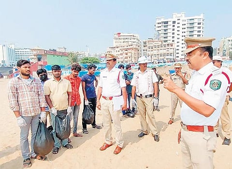Drunk drivers cleaning RK Beach as punishment.