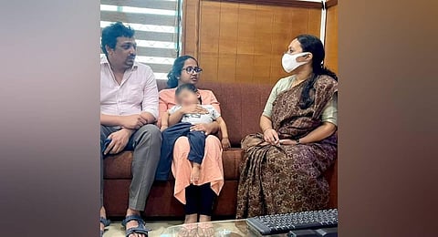 Nirvaan and his parents with Kerala health minister Veena George. (Photo | Express)