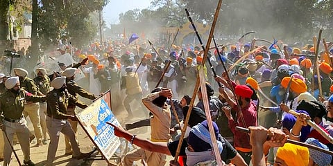 Followers of Amritpal Singh clash with the police while breaking through barricades at the police in protest against filing of FIR against him and his associates, at Ajnala, Amritsar. (Photo | PTI)
