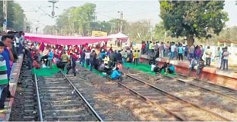 Members of Bamra Rail Kriyanusthan Committee squatting on the tracks | Express