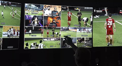 A live-stream producer points a screen in the production control room on a Kings League match day.(Photo | AFP)