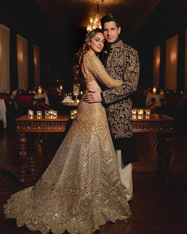 Manish Malhotra described the groom's look: 'Sidharth chose majestic charm, wearing a tailor-made velvet sherwani in a stark combination of black and gold. Crafted with intricate threadwork and precious swarovski crystals the A-symmetrical kurta reveals a subtle twist exploring the perfect balance between cultural roots, and cutting-edge aesthetics.' (Photo | Kiara Advani Instagram)