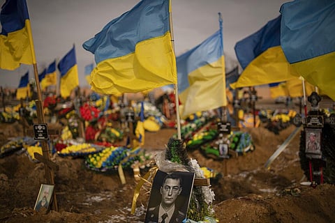 A photograph of a Ukrainian serviceman is placed on his grave in the Alley of Glory part of the cemetery in Kharkiv, Ukraine, Friday, Feb. 24, 2023. (Photo | AP)