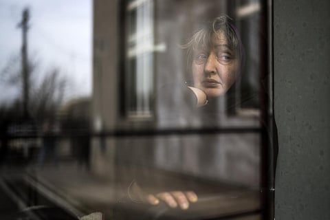 A woman who fled a nearby village looks out from a window of a church in Bashtanka, Mykolaiv district, Ukraine, on Thursday, March 31, 2022. (File Photo | AP)