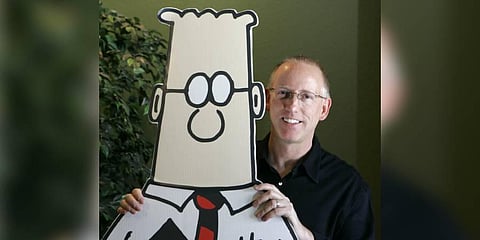 Scott Adams, creator of the comic strip Dilbert, poses for a portrait with the Dilbert character in his studio in Dublin, California (File Photo | AP)