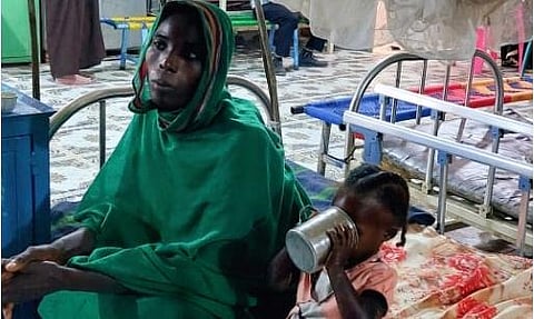 A woman and a child sit waiting at a nutrition centre at the Kalma camp for the displaced just outside Nyala, the provincial capital of South Darfur state (Photo | AFP)