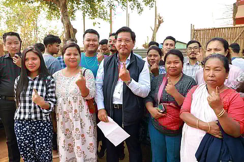 Meghalaya Chief Minister and National People's Party (NPP) candidate from South Tura constituency Conrad K Sangma shows a thumbs-up sign as he waits in a queue to cast his vote for the State Assembly elections, at a polling booth, Tura, in West Garo Hills on Monday. (Photo | ANI)