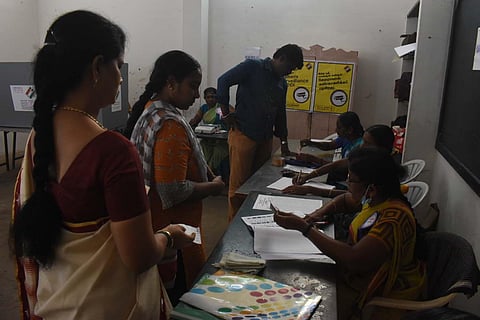 Constituents line up to vote at a polling station in Erode, for the Erode East constituency by-election, on Monday. (Photo | S Senbagapandiyan, EPS)