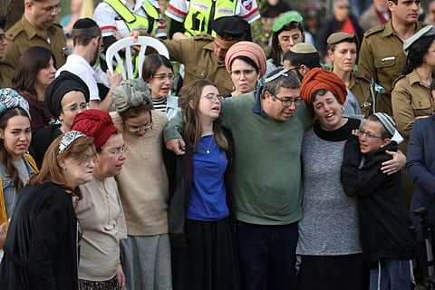 The parents of Israeli settlers, brothers Yagel Yaniv, 20, and Hallel Yaniv, 22, mourn during their funeral at the military cemetery in Jerusalem. (Photo | AFP)
