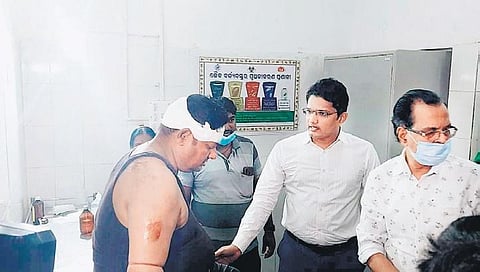 Balasore collector interacting with Chouhan’s injured driver at the hospital | Express