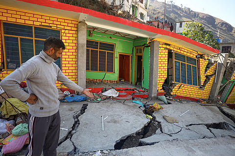 A resident shows cracks that have appeared in his house in Nai Basti area, in Doda district, Jammu & Kashmir (Photo | PTI)