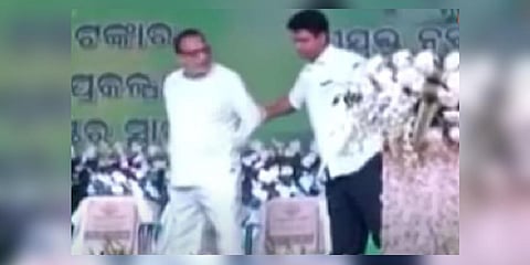 A screengrab from the viral video where BJD leader Rabi Nanda is seen being nudged off stage by party org secy Pranab Das Nanda. (Photo | Youtube)