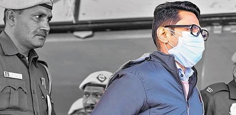 Shankar Mishra, the accused who urinated on a woman passenger on an Air India flight from New York to Delhi, with the police personnel at IGI Airport in New Delhi a few days back | PTI