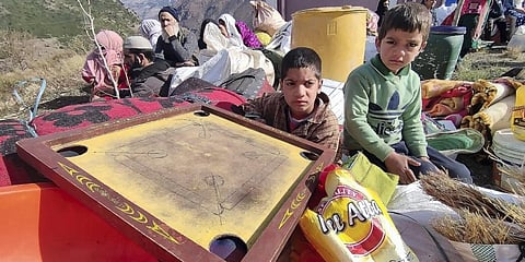 Residents shift their belongings from the land subsidence-affected Nai Basti area, in Doda district, Jammu & Kashmir. (Photo | PTI)